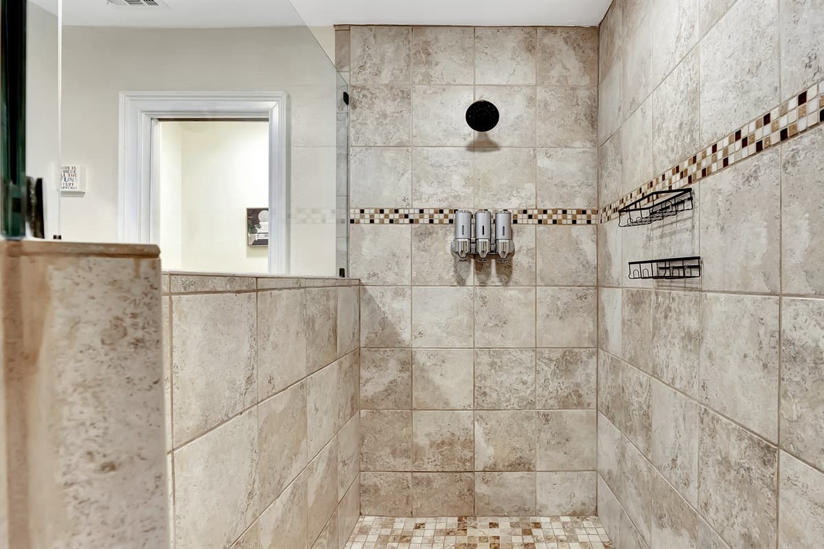 The walk-in shower beckons with its modern allure, providing a spa-like experience.