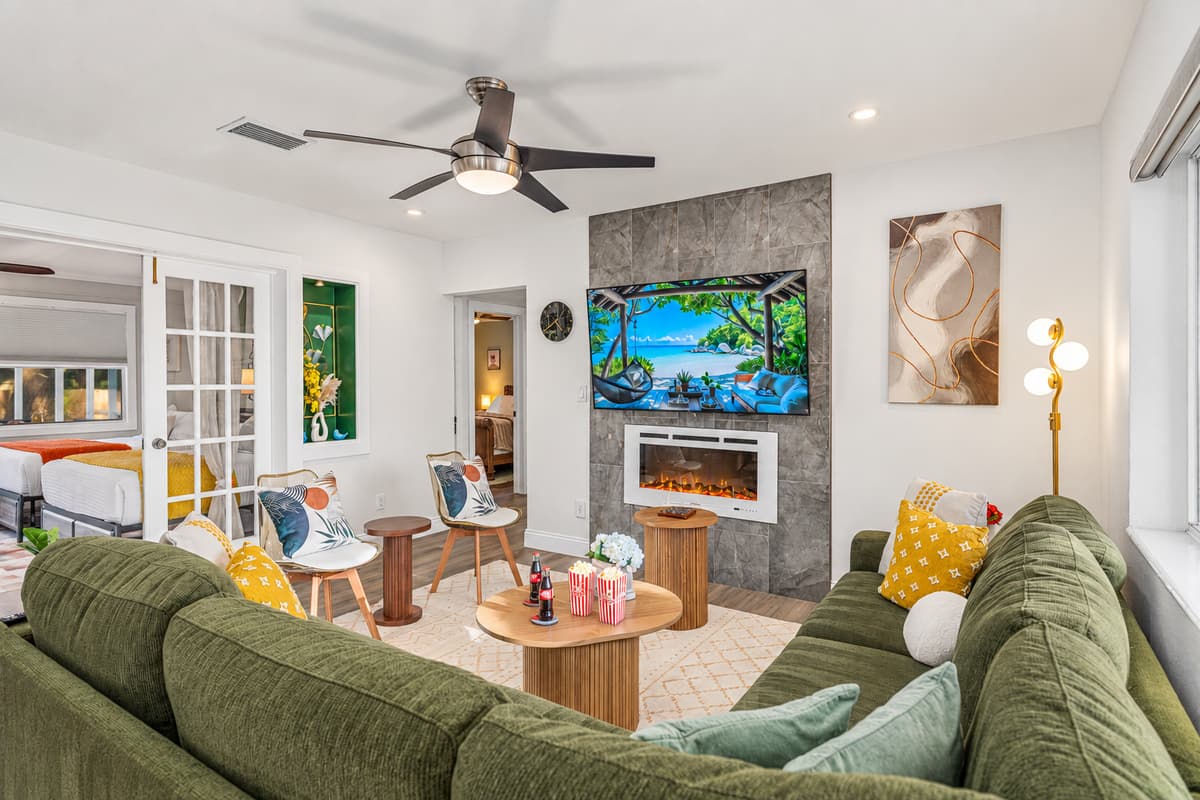 A bright, open living room featuring a plush sectional, stylish accent chairs, and abundant natural light—perfect for relaxing or gathering with loved ones.