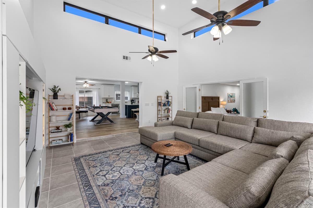 Stay cool and cozy with dual ceiling fans and soft, neutral-toned furniture.