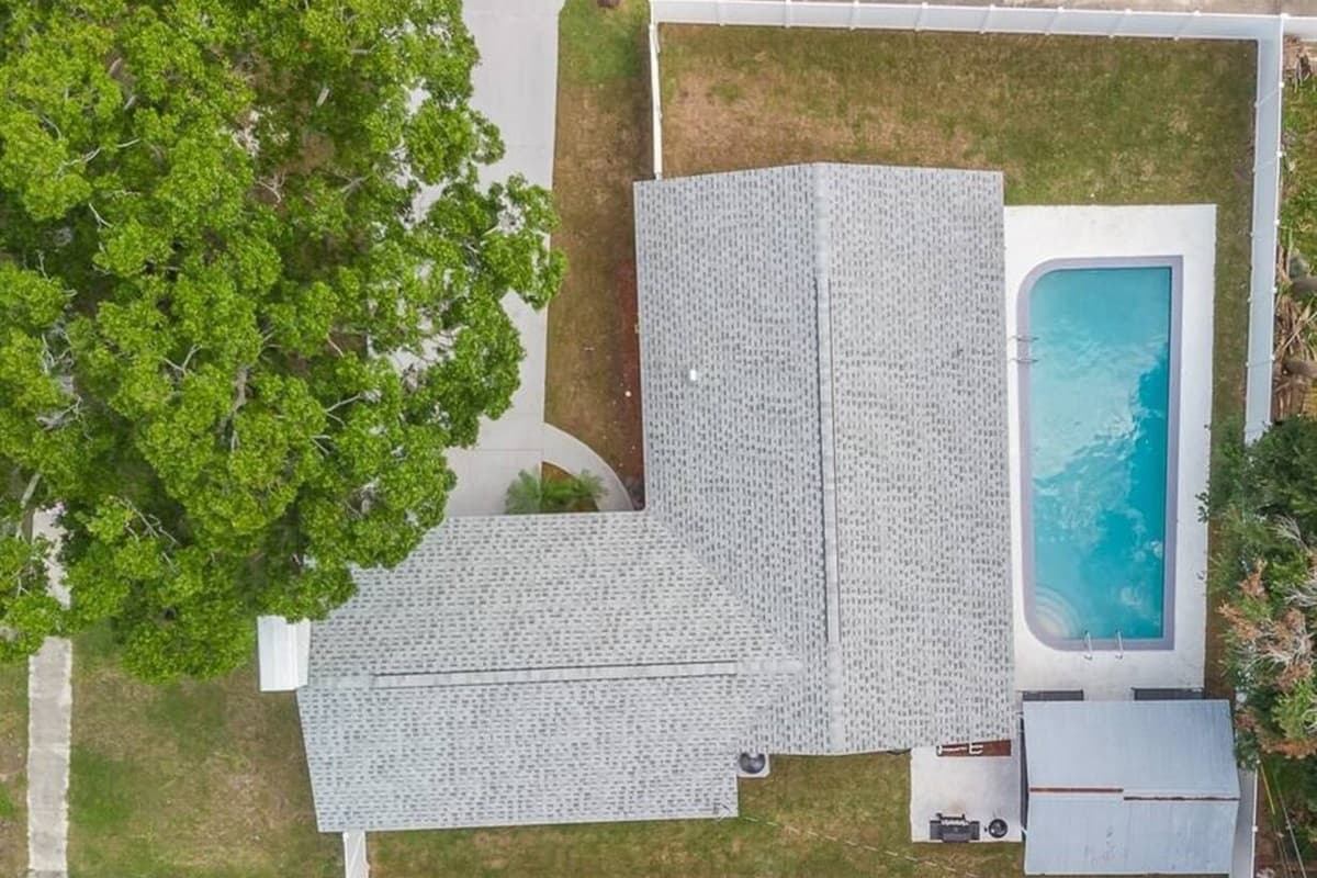 Top view of our immaculate property showcasing the stunning heated pool and lounge area at the back of the property. Love what you see? Ask us questions and send us an inquiry as soon as possible!