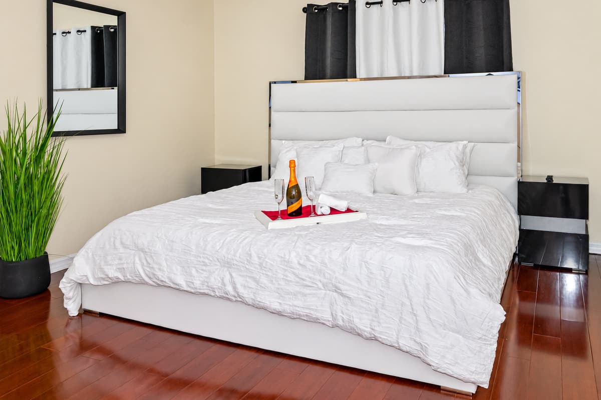 The bed is the centerpiece of the room, with its plush mattress, inviting you to sink into a deep slumber.