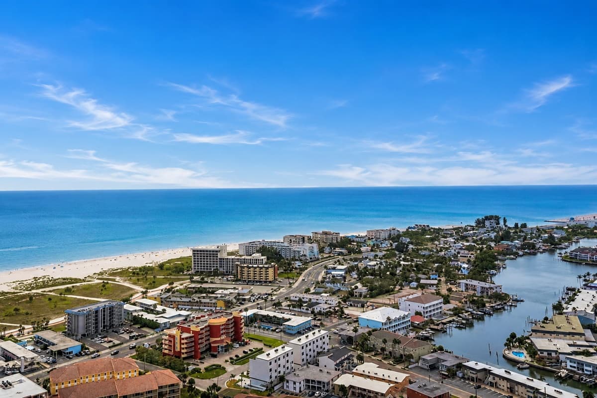 Expansive waterfront aerial showcasing the nearby beaches, canals, and tropical scenery.