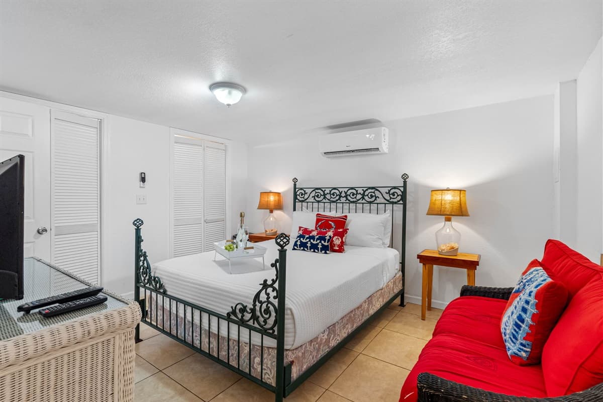 The bed on this bedroom is dressed in soft, inviting linens, and complemented by plush pillows, creating a perfect retreat after a day of beachside adventures.