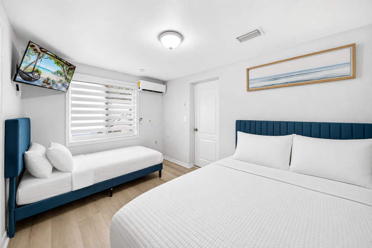 Large primary suite featuring a king bed, cozy daybed seating area, Smart TV, and plenty of room to relax and unwind.