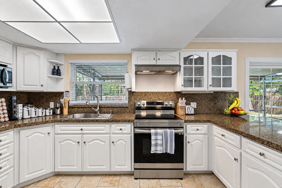 From the rich, warm tones of the cabinets to the gleaming stainless steel finishes, this kitchen is both stylish and functional.