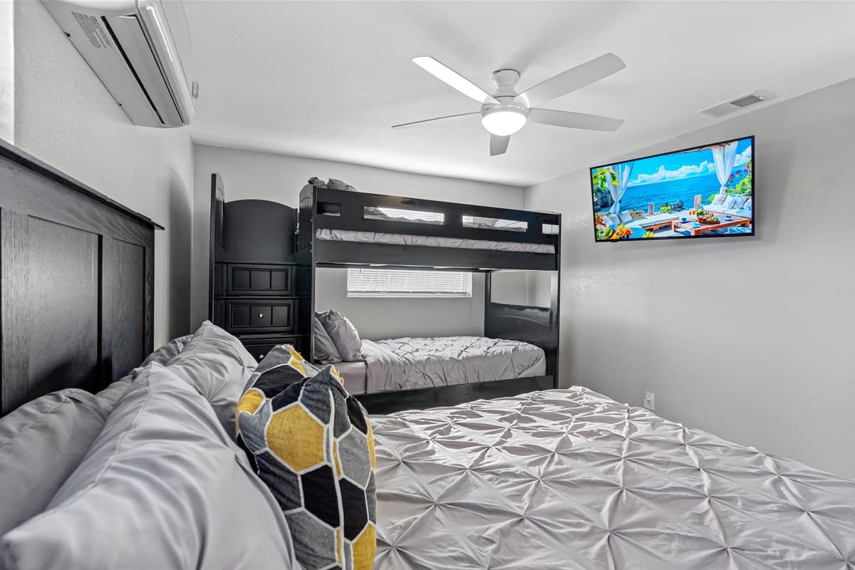 Well decorated bedroom, featuring a queen-size bed and a smart TV. Feel completely comfortable during your stay as you make unforgettable memories with your loved ones.