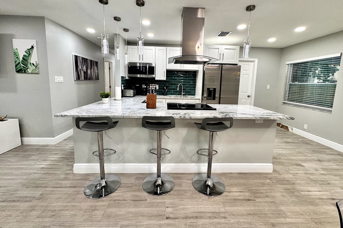 This modern culinary space features brand-new stainless-steel appliances, including a refrigerator, oven, microwave, and dishwasher, ensuring you have everything you need to prepare meals effortlessly.