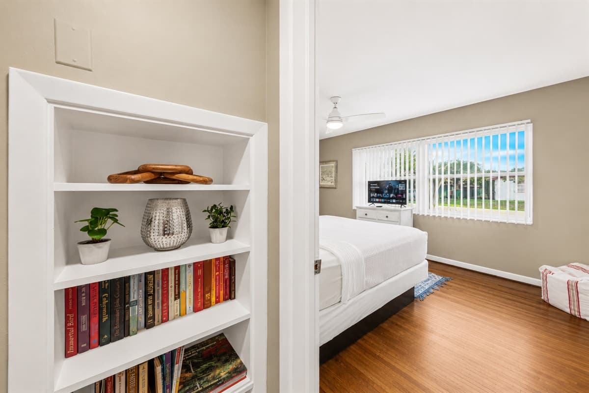 Charming bedroom entry view with decorative shelving and a welcoming, homey atmosphere.