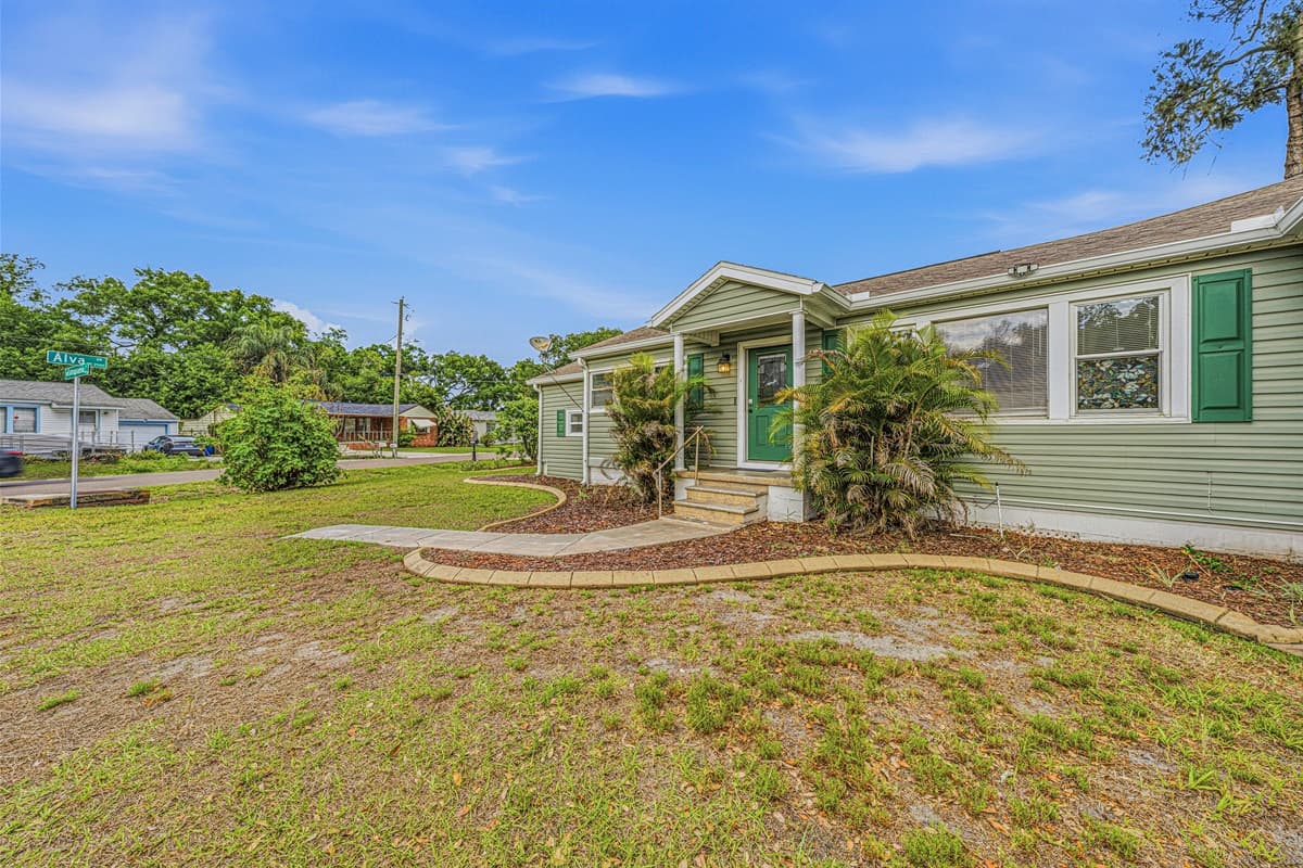 Charming front exterior with inviting entryway and landscaped walkway leading to the home.