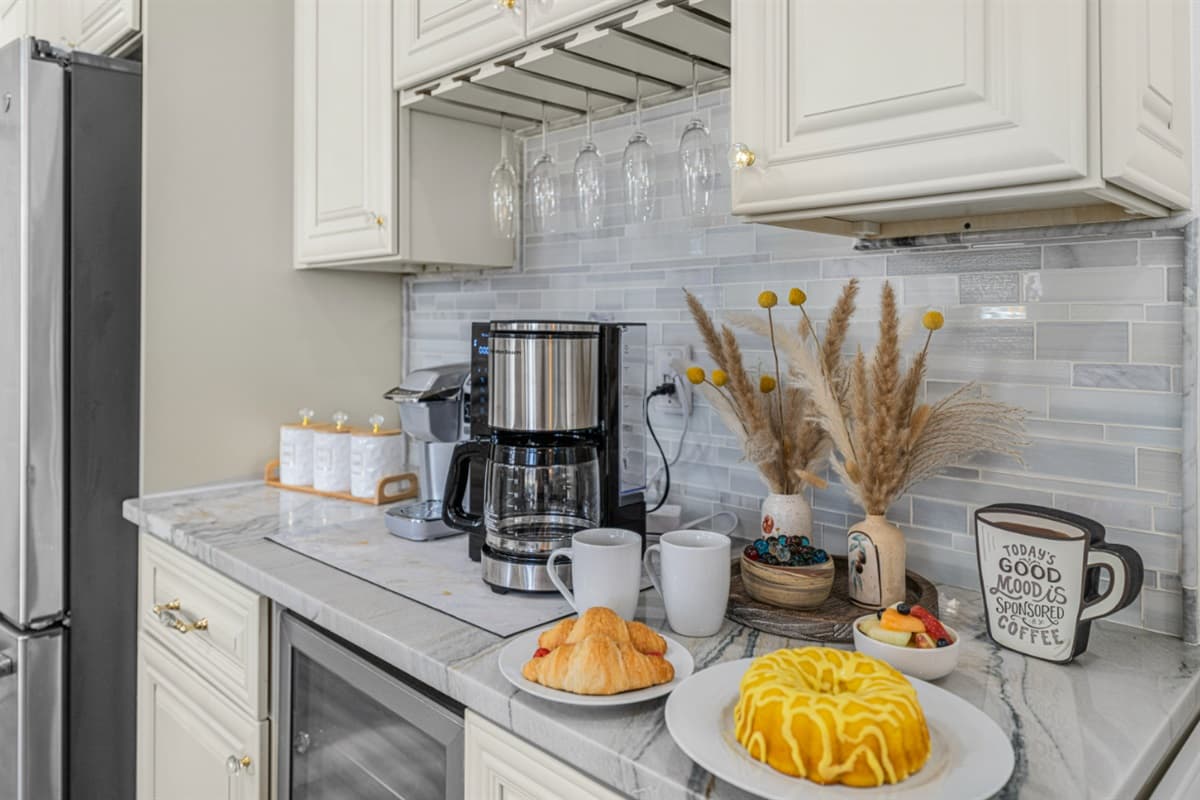 A bright and inviting coffee station set within a beautifully designed kitchen. Welcoming touch—perfect for enjoying a relaxing morning at the property.