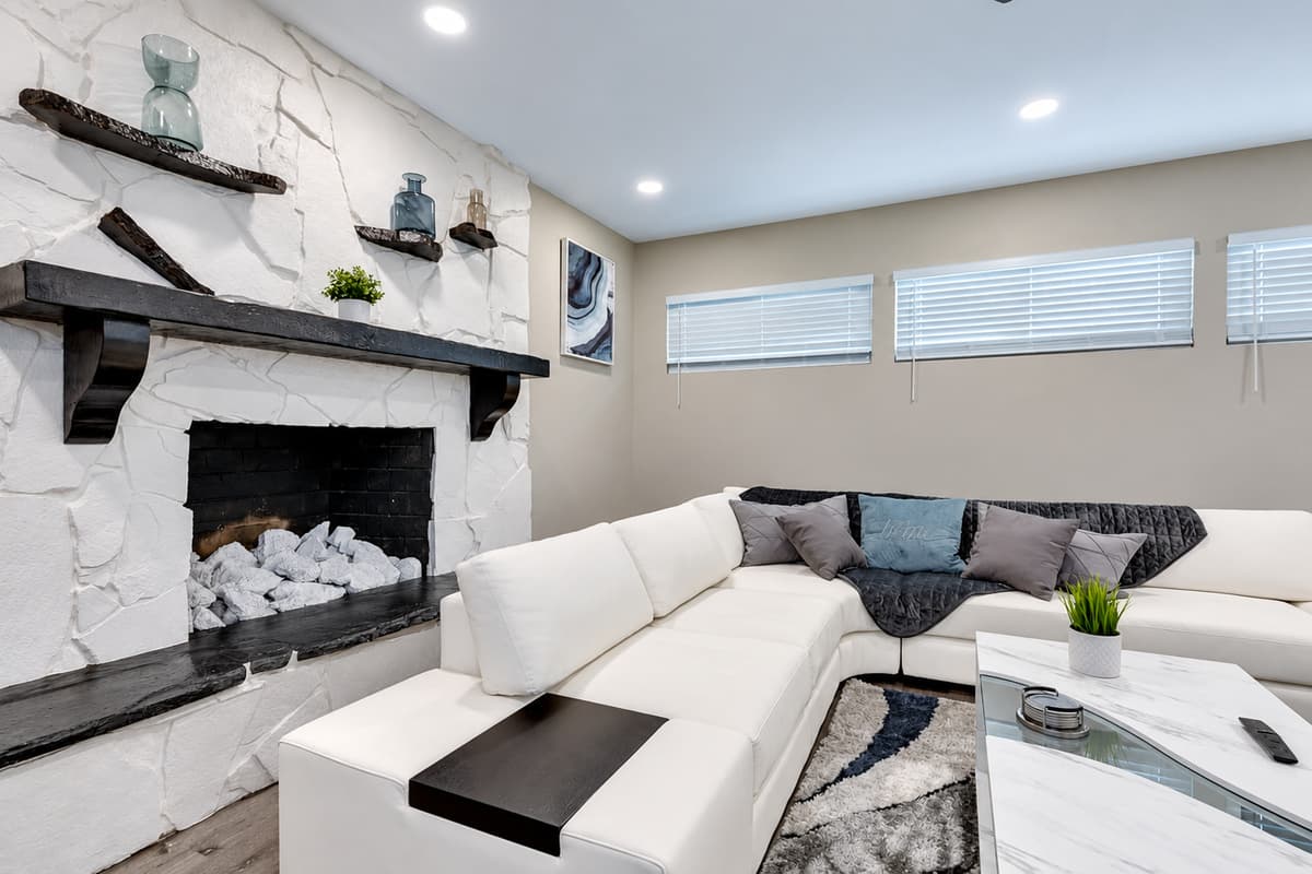 Feel cozy and comfortable while relaxing in our beautiful living room with a magnificent fireplace, L-shaped modern couch and smart TV. If you are interested in this property, send us an inquiry right away!