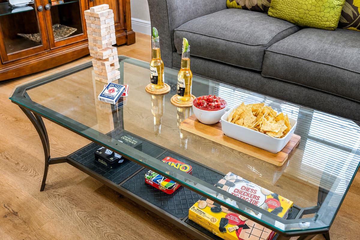 This thoughtfully styled coffee table scene invites guests to kick back, connect, and enjoy a little friendly competition—all from the comfort of your cozy living room.