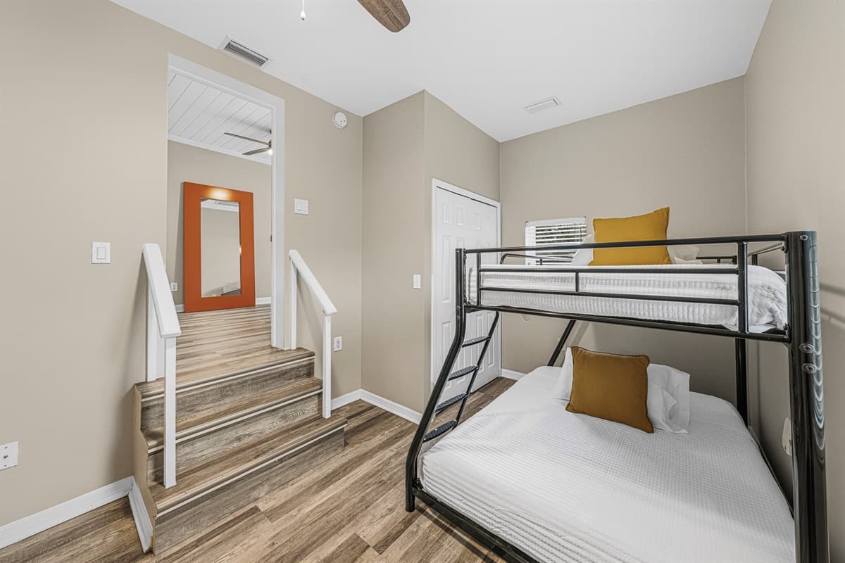 Bunk room with comfortable beds and nearby stair access—great for families or group stays.