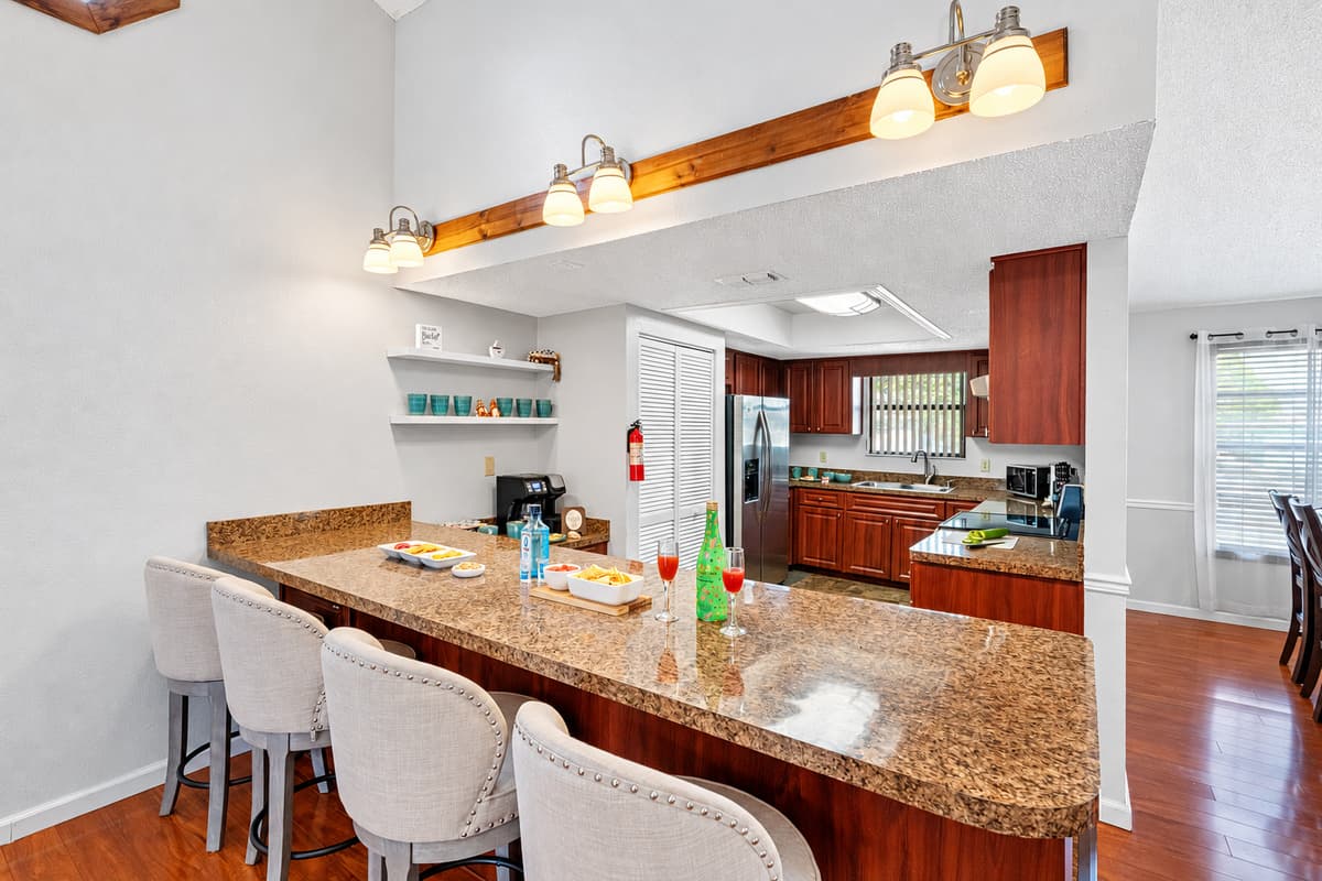 The extended countertops double as a bar, making this kitchen a great hub for casual dining, wine and cheese nights, or morning coffee chats.