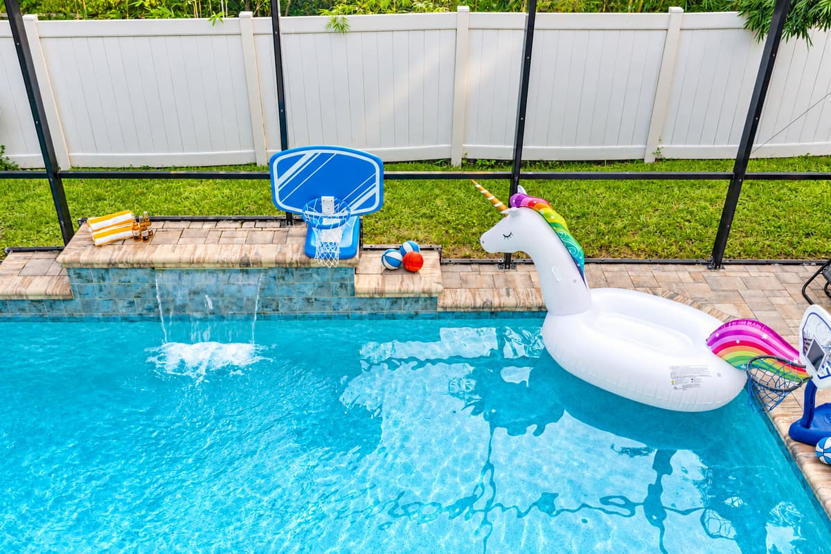 Unwind under the cascading water feature or float lazily beneath the screened ceiling—your peaceful pool escape awaits.