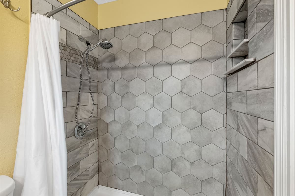 Modern bathroom featuring a sleek walk-in shower with stylish tile finishes.