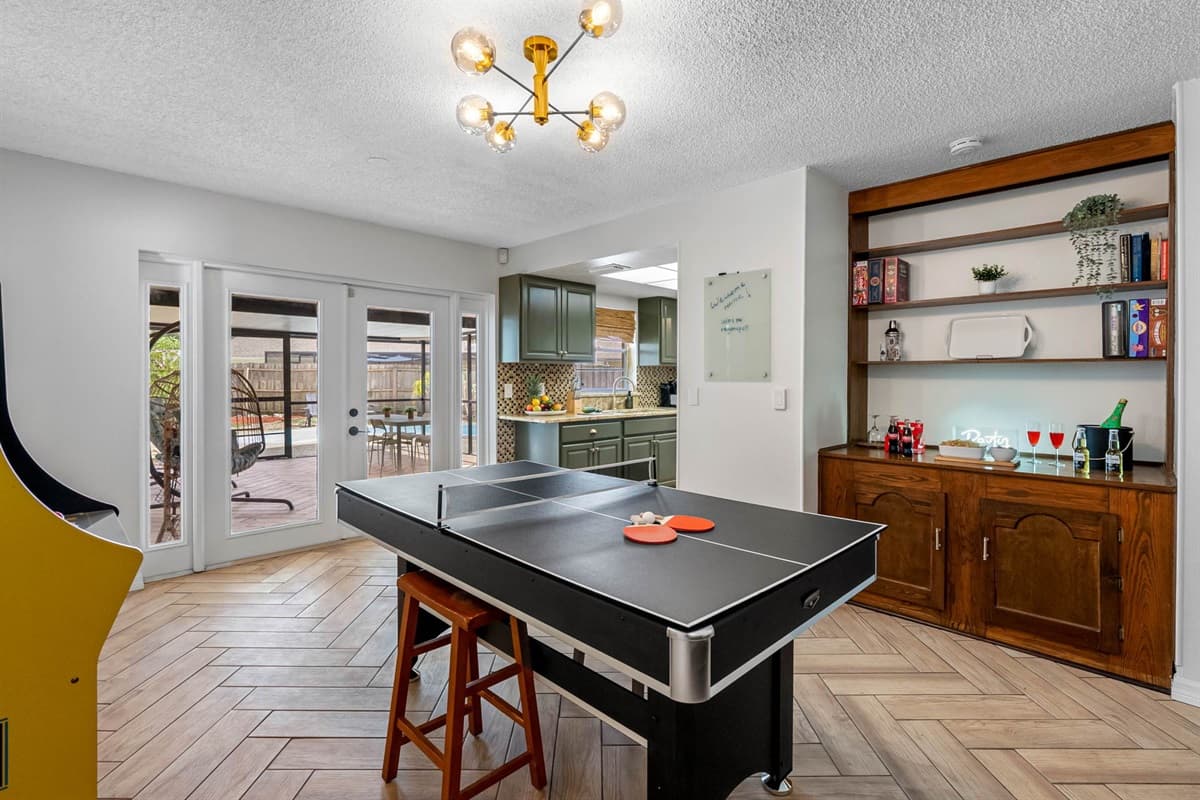 Step into a space that mixes old-school fun with modern comfort. Play a round of Pac-Man, throw some darts, or unwind on the mid-century sofa with music or games. Bonus: access to the patio is just steps away!