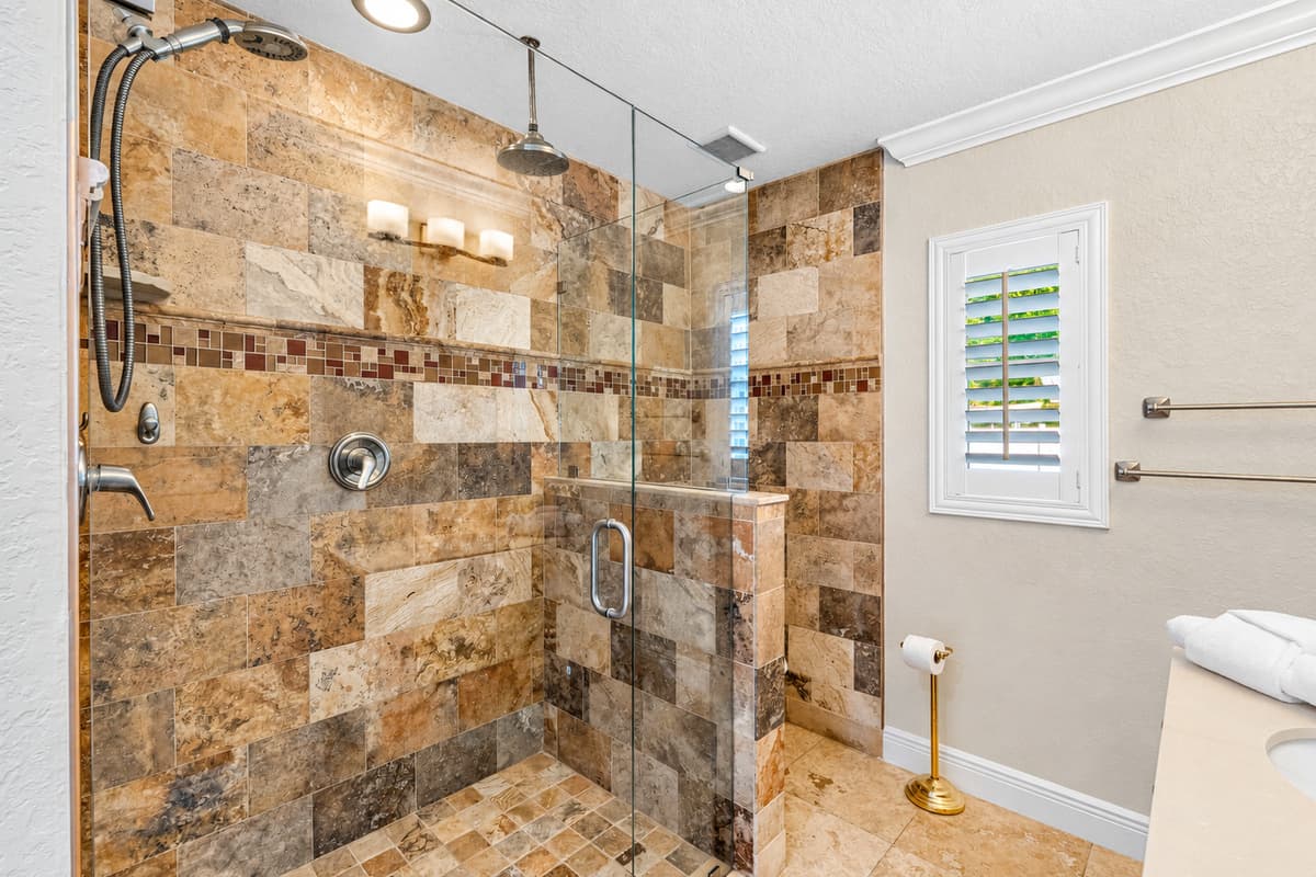 This stylish bathroom features an enclosed walk-in shower with modern tilework and excellent water pressure.