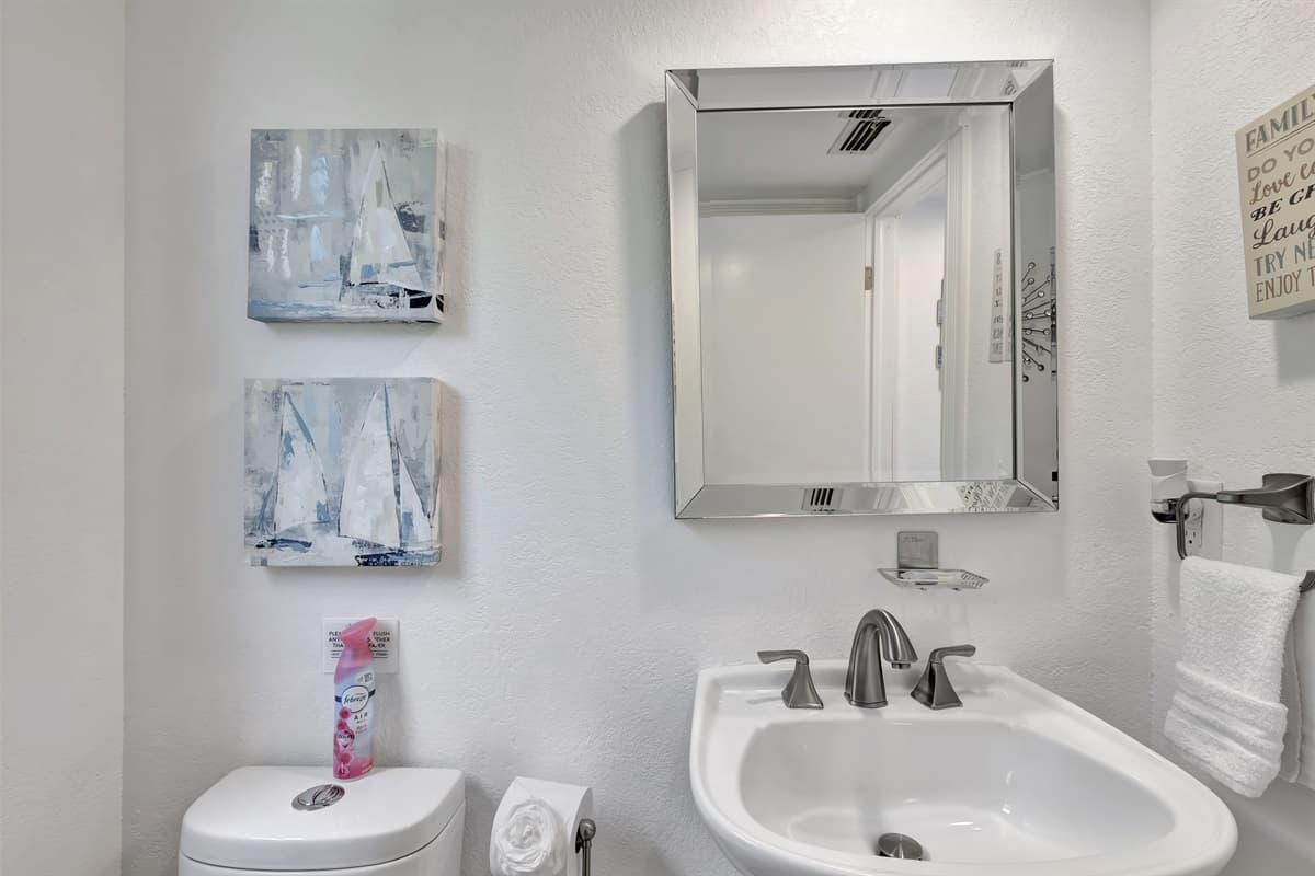 To enhance the functionality of this half bathroom, soft, ambient lighting has been installed, offering just the right amount of illumination without being overpowering.