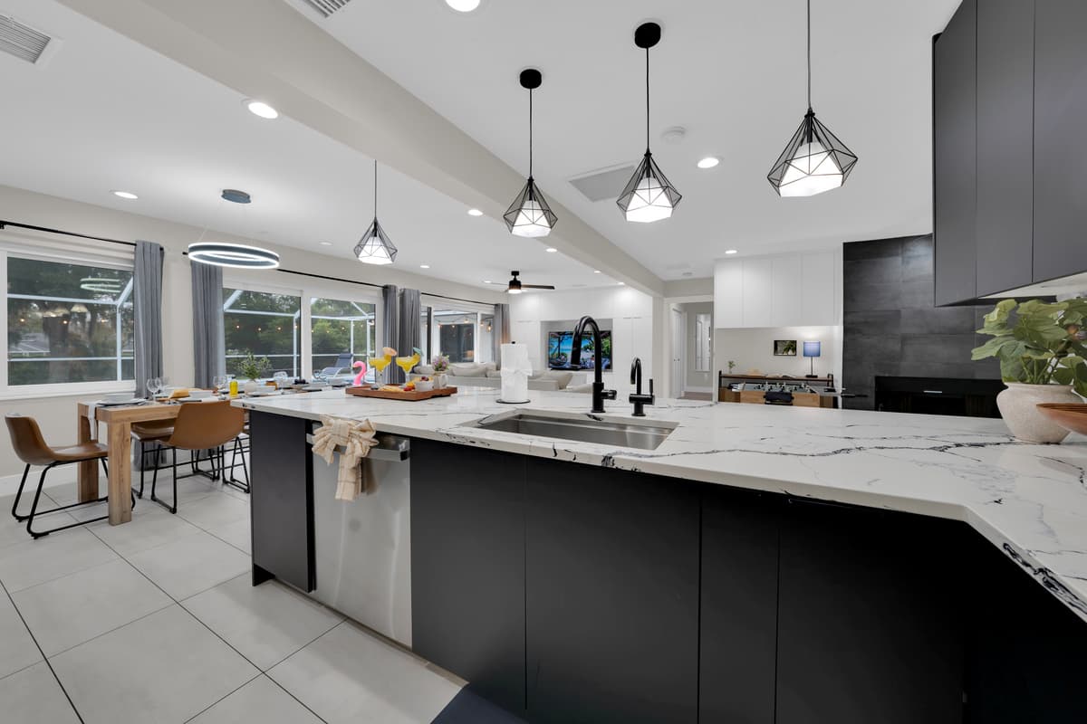 A beautifully designed kitchen where every detail, from the spacious sink to the dining and living areas, feels effortlessly connected