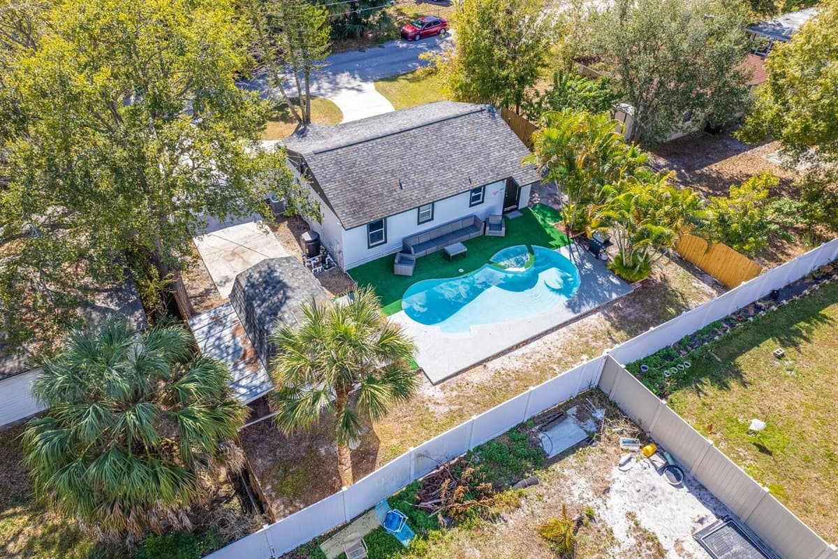The aerial back side of the property showcasing our immaculate heated pool