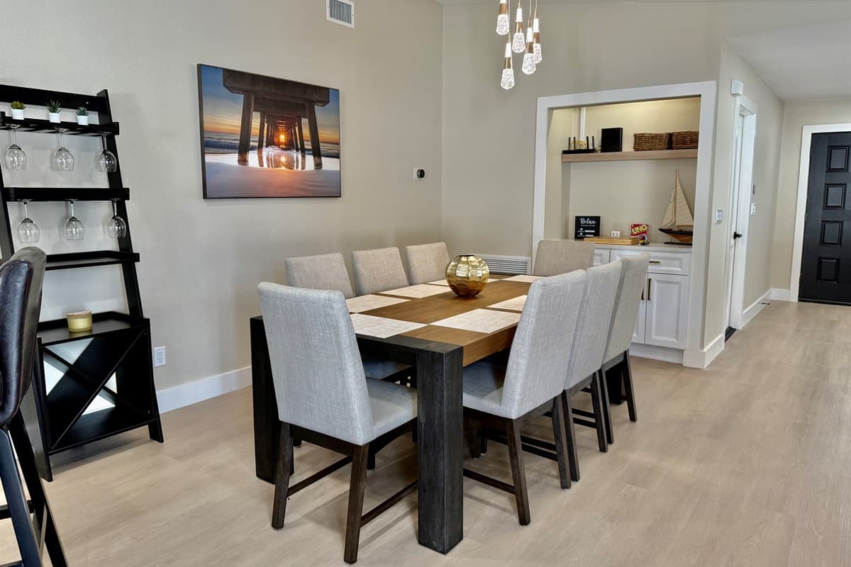 Enjoy delicious meals in this modern space featuring stylish lighting and warm tones.