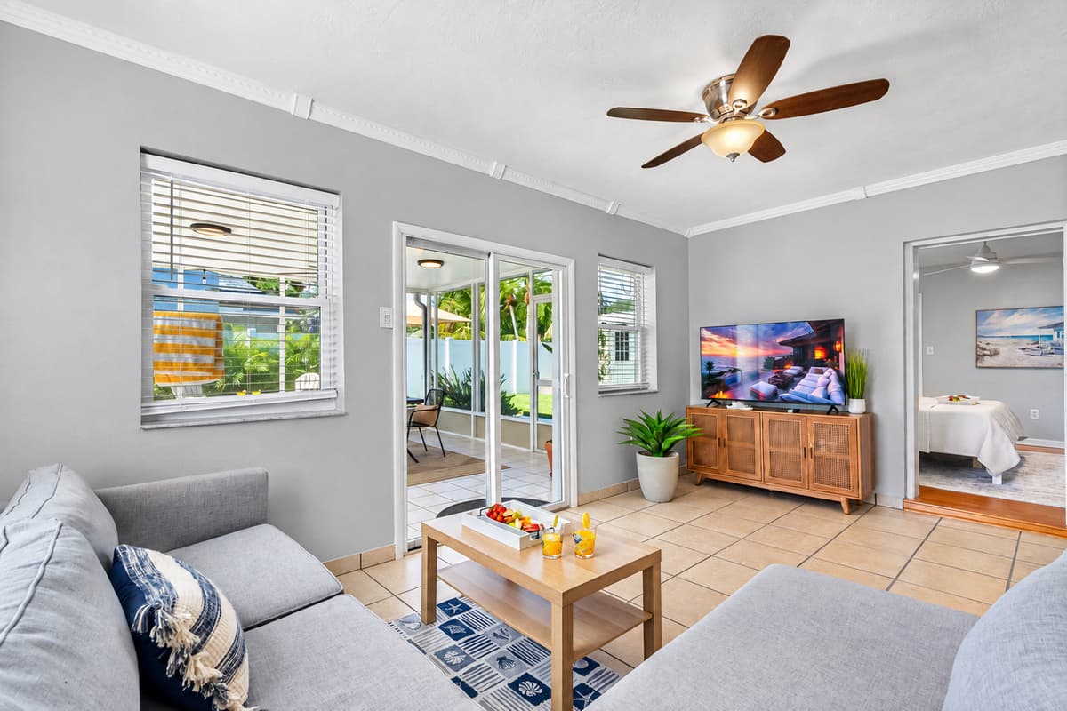 Your favorite streaming apps are just a click away on the large smart TV, surrounded by cozy armchairs and a deep, soft sofa.