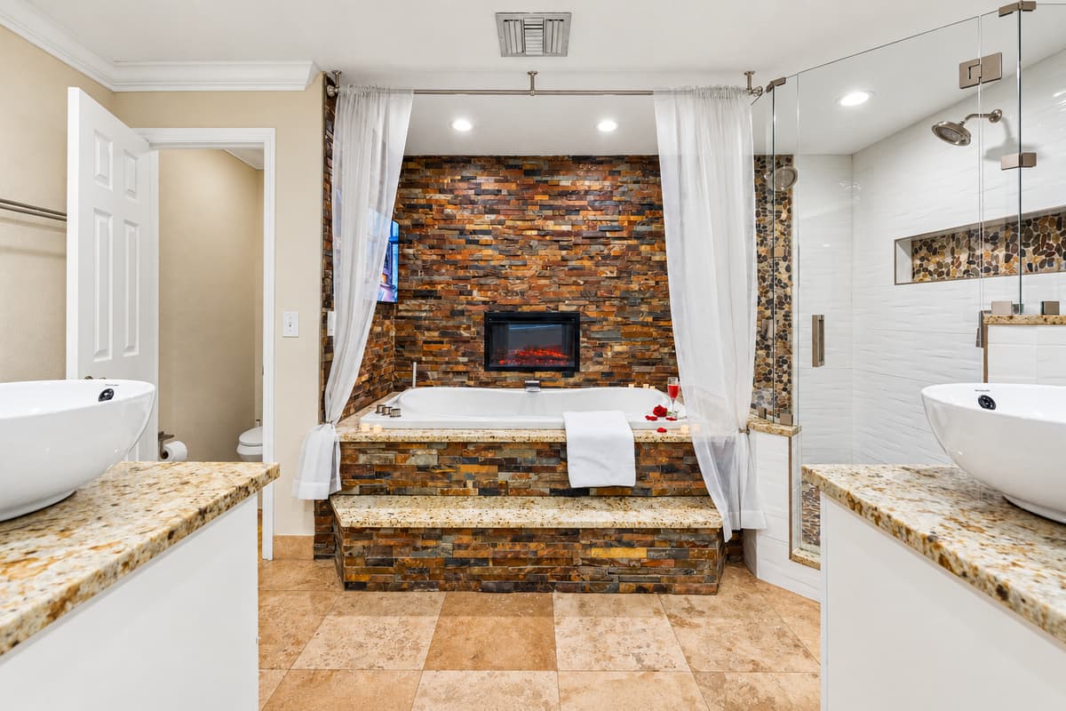 Just steps away, a separate glass-enclosed walk-in shower offers a refreshing alternative for a quick rinse.