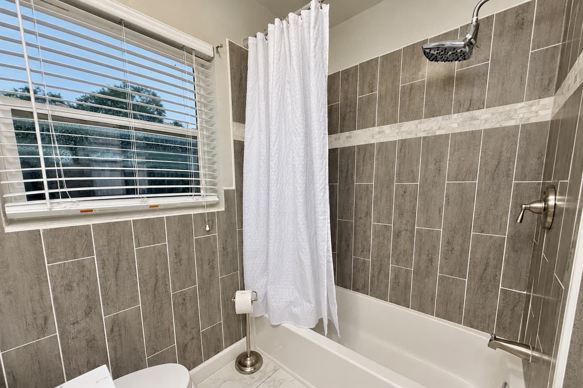 Start your day in a sparkling clean space with modern fixtures, soft lighting, and all the essentials waiting for you.