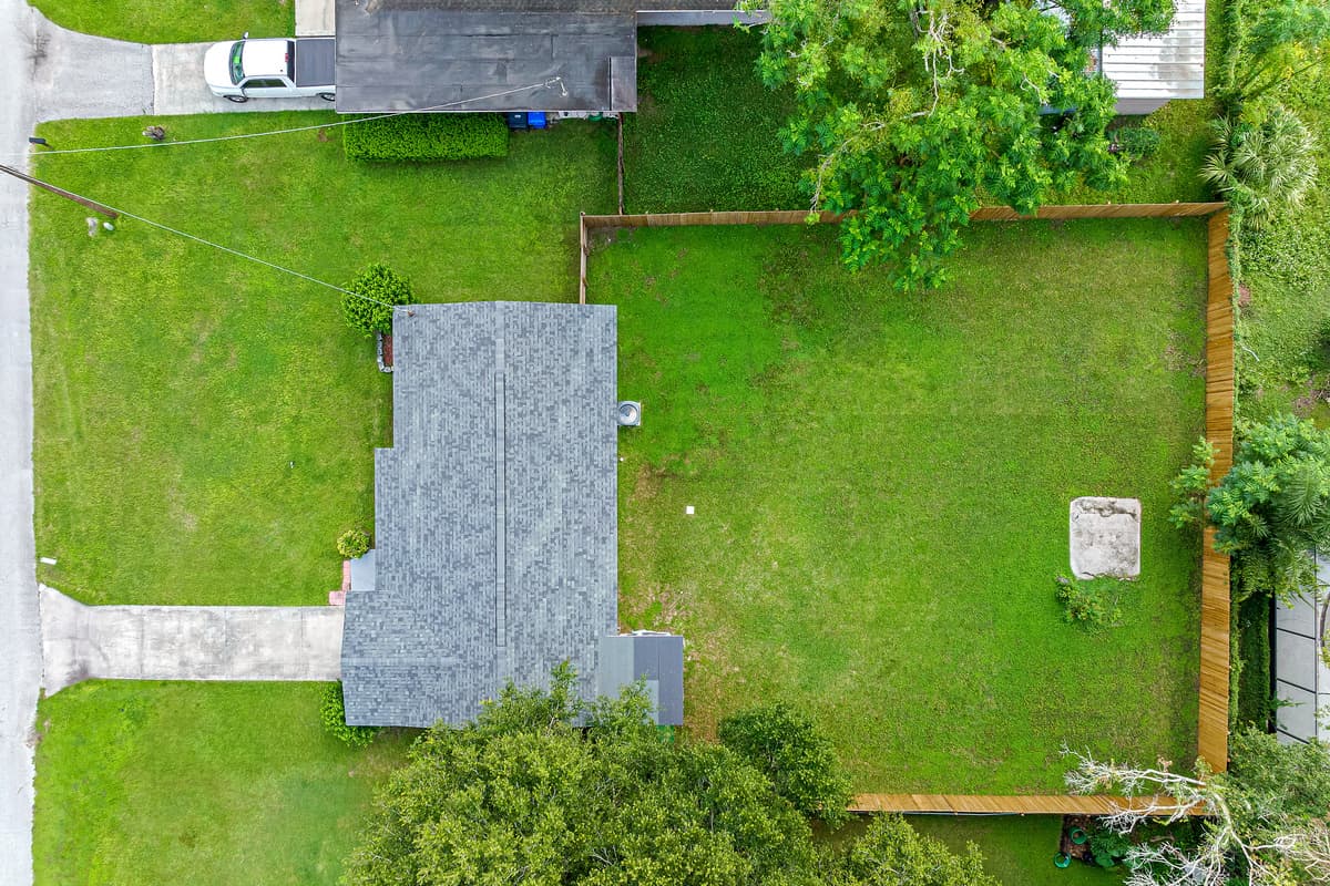 Top view of our beatiful property showcasing the spacious fully fenced backyard, the well maintained frontyard and the driveway! Book with us now! Love what you see? Ask us questions and send us an inquiry as soon as possible!