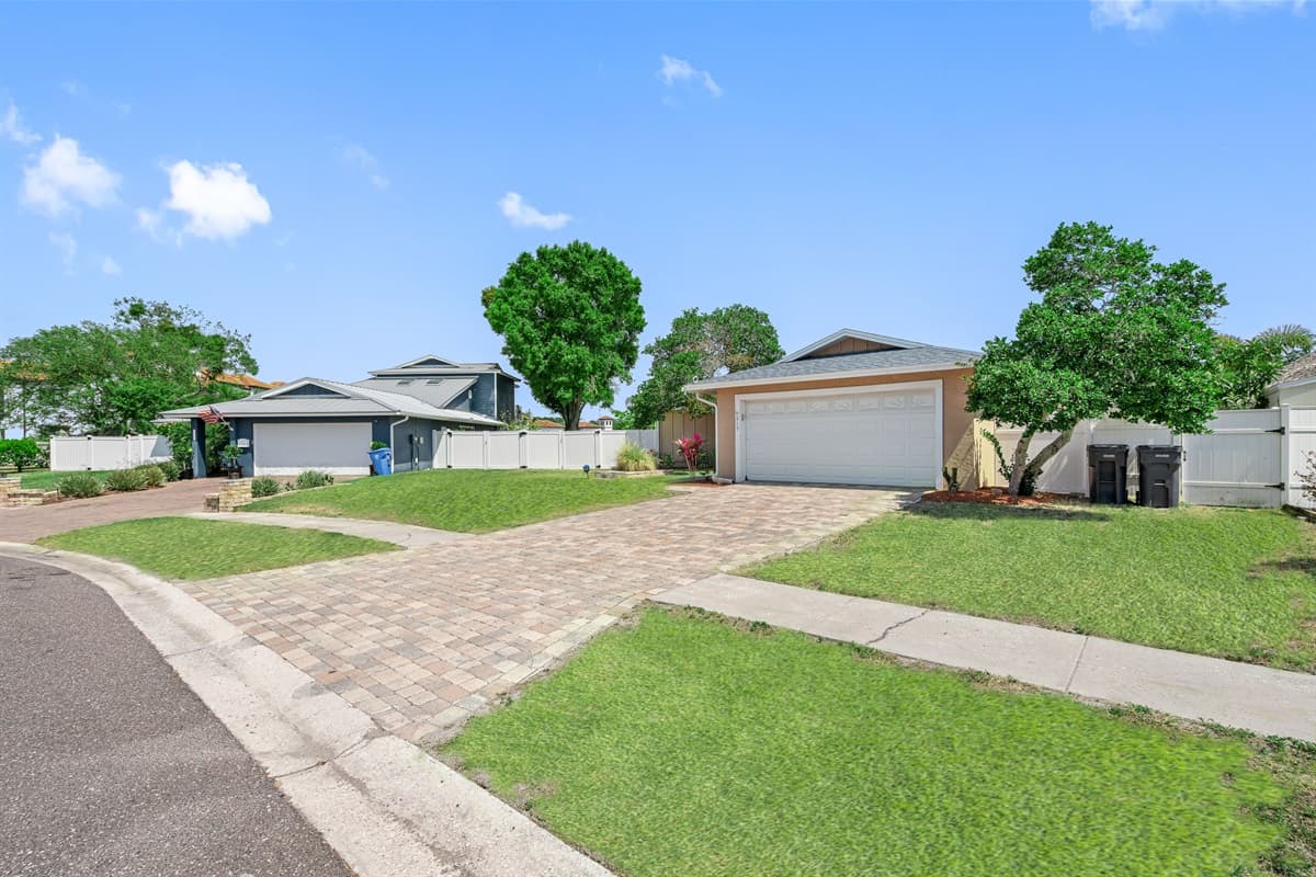 The carefully curated garden beds and manicured lawn accentuate the home's beauty.
