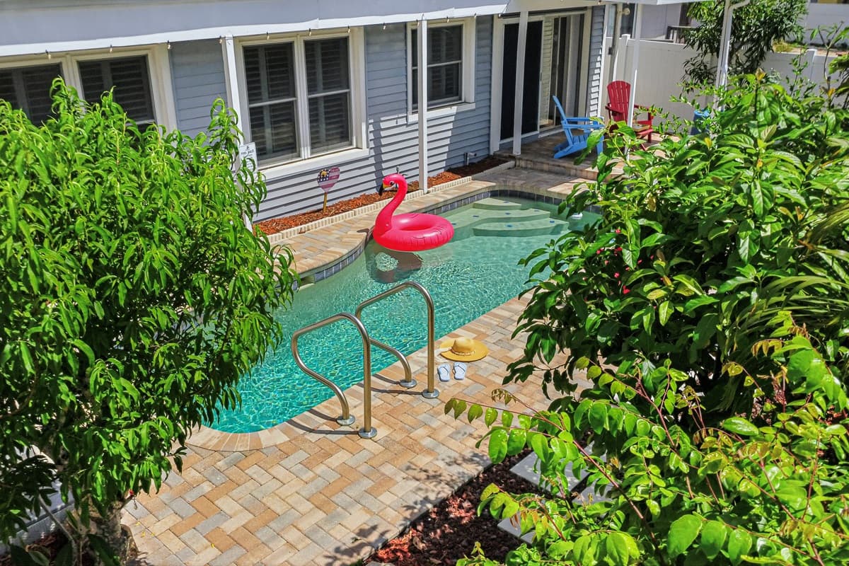 Poolside view framed by tropical landscaping, creating a peaceful and private oasis 