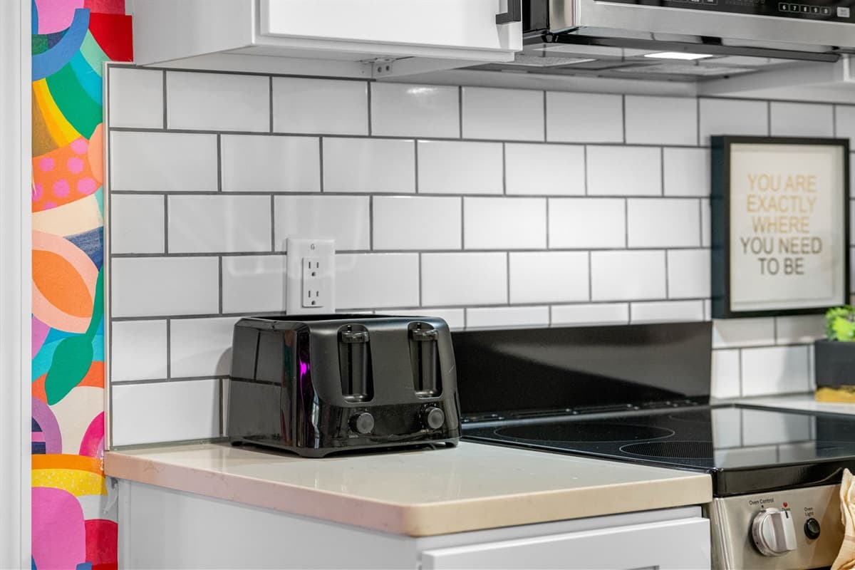 The kitchen is equipped with the latest state-of-the-art appliances, all seamlessly integrated into the design to maintain the sleek aesthetic.