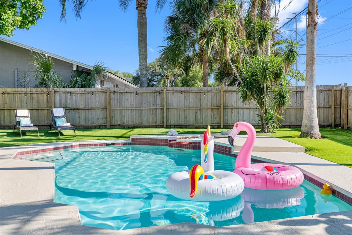The pool itself is expansive, offering plenty of space for swimming, splashing, or simply floating on the crystal-clear water.