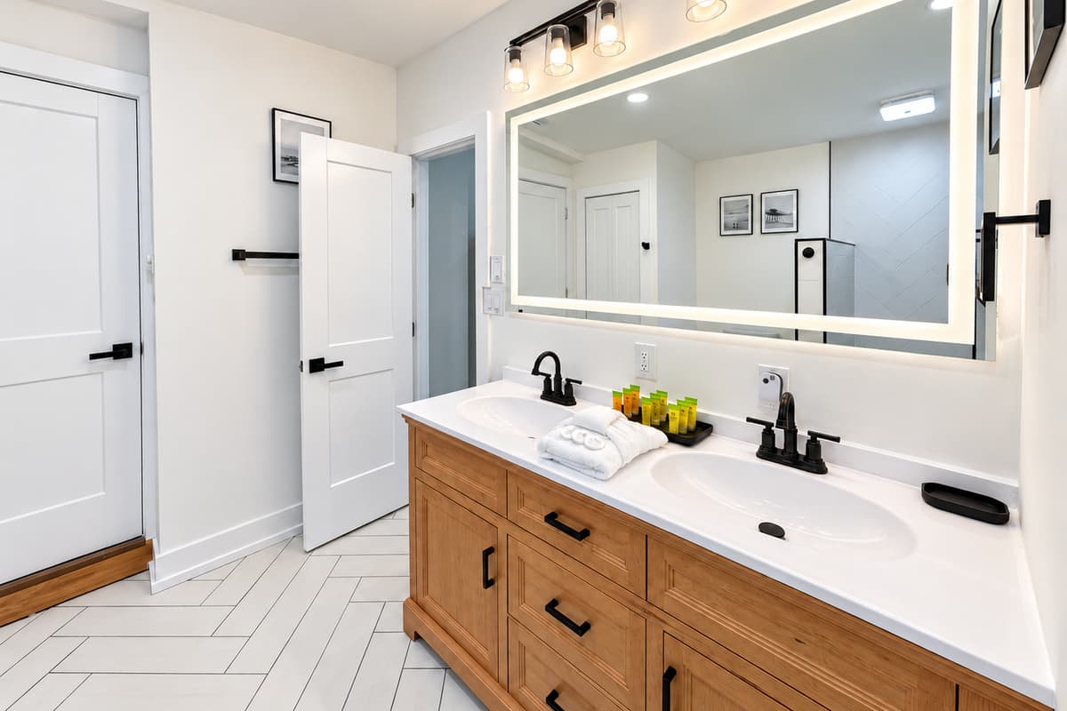 Bathroom 1 with a double vanity and walk-in shower.