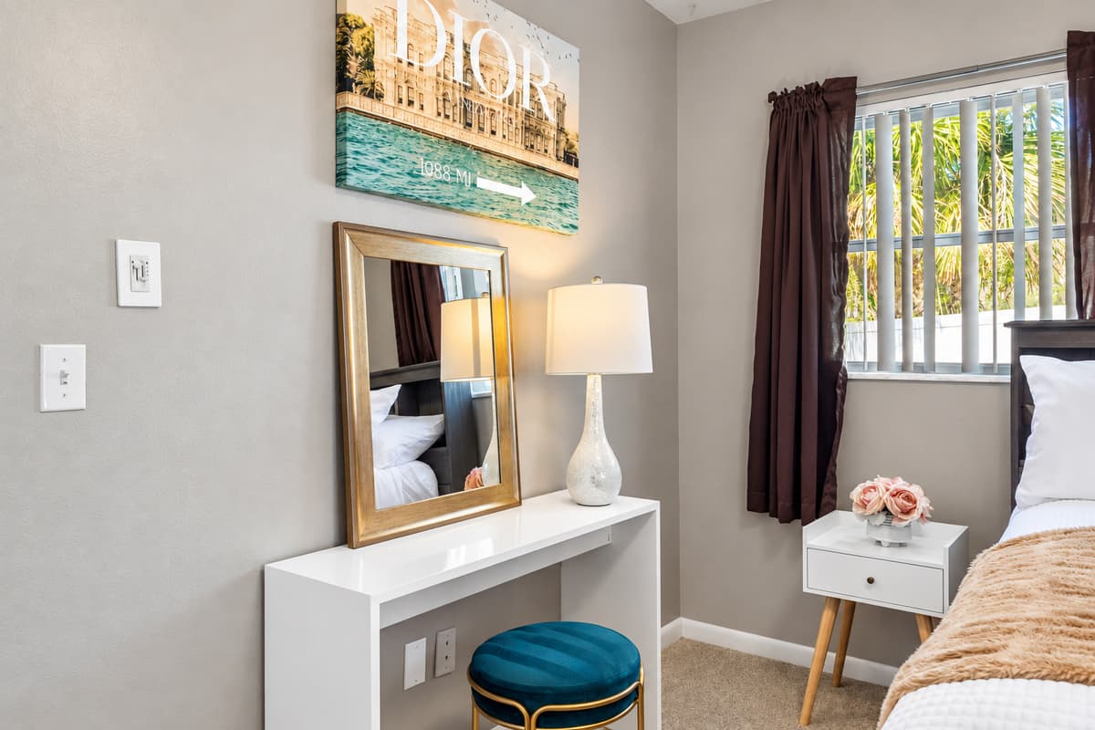 Large mirrored closets reflect natural light, making the room feel even more spacious and bright.