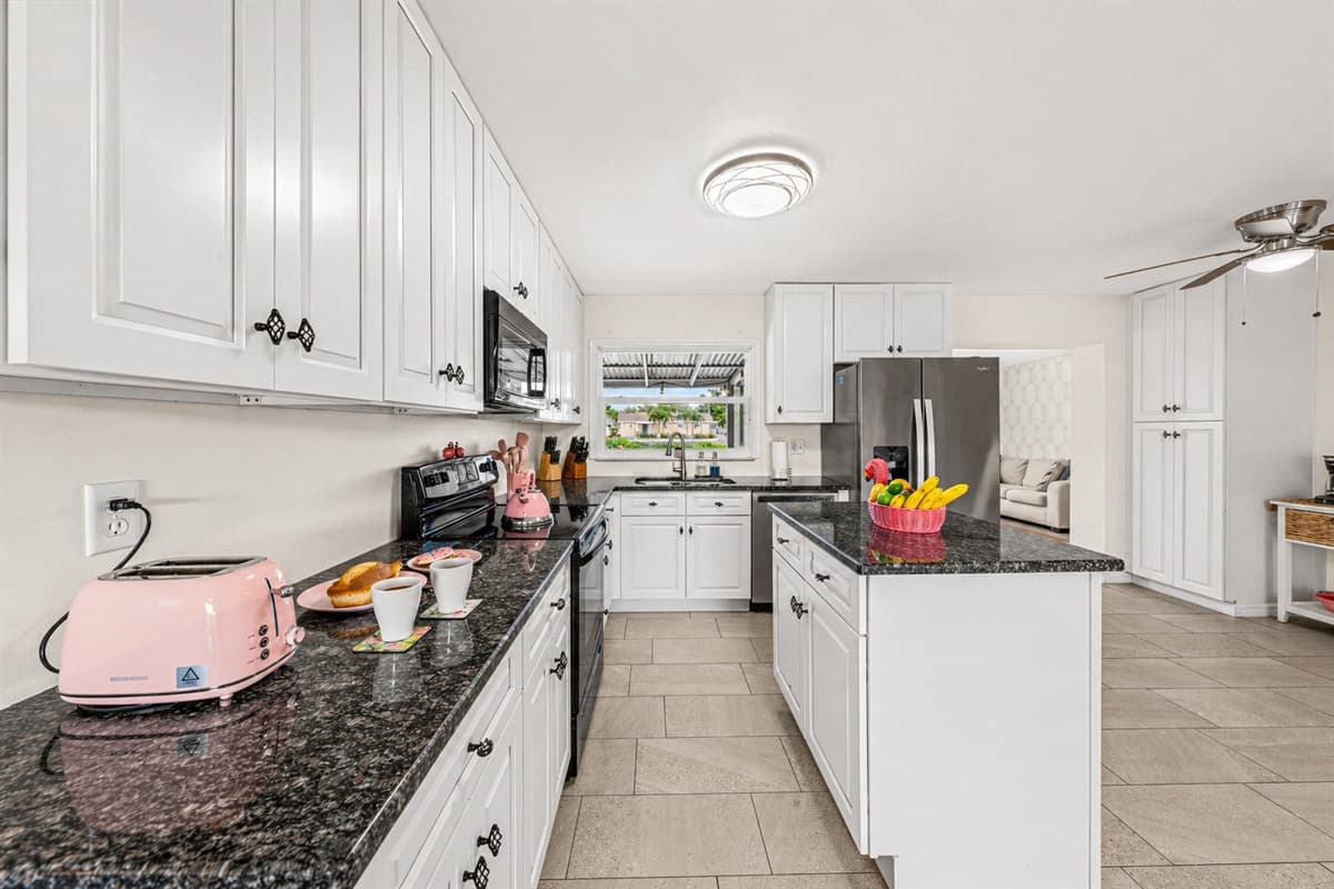 Extended counter space with small appliances and convenient layout for easy cooking.