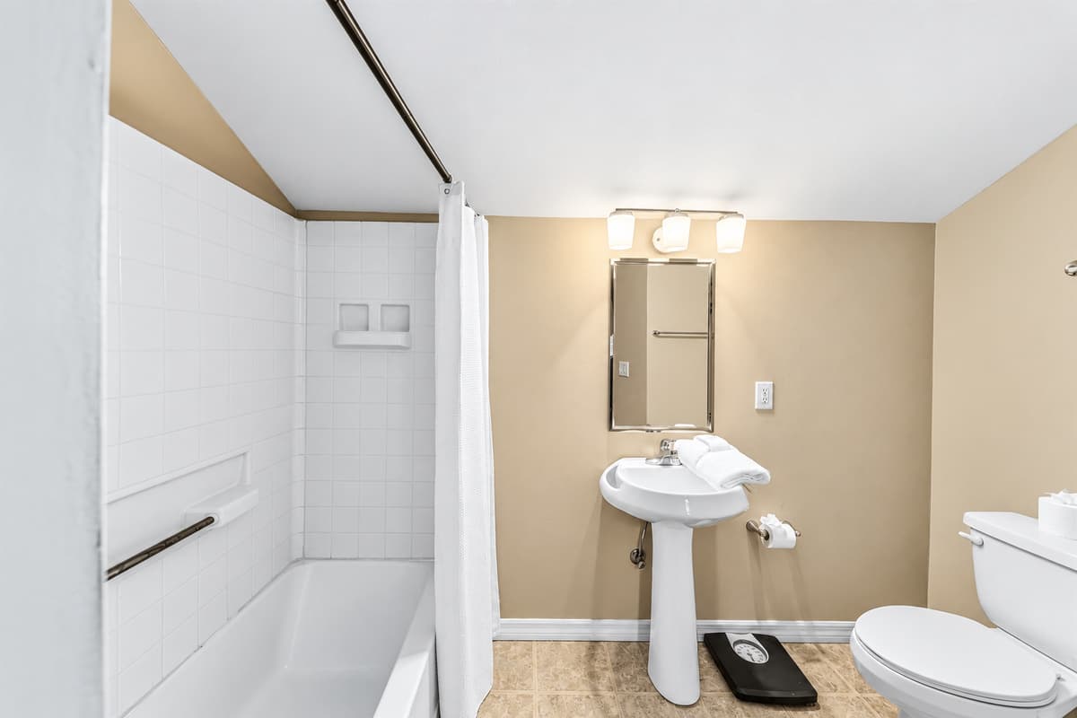 Additional full bathroom with simple, clean design and essential amenities.